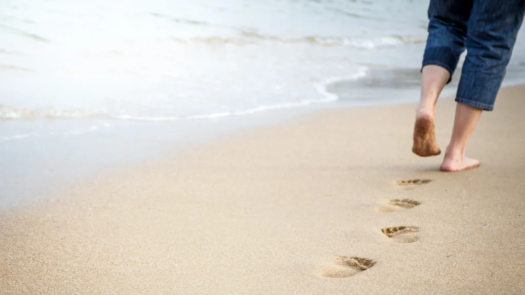 Image of footprints on beach to signify walking