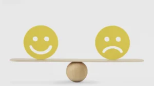 Happy & Sad Emotion balanced on a see-saw.