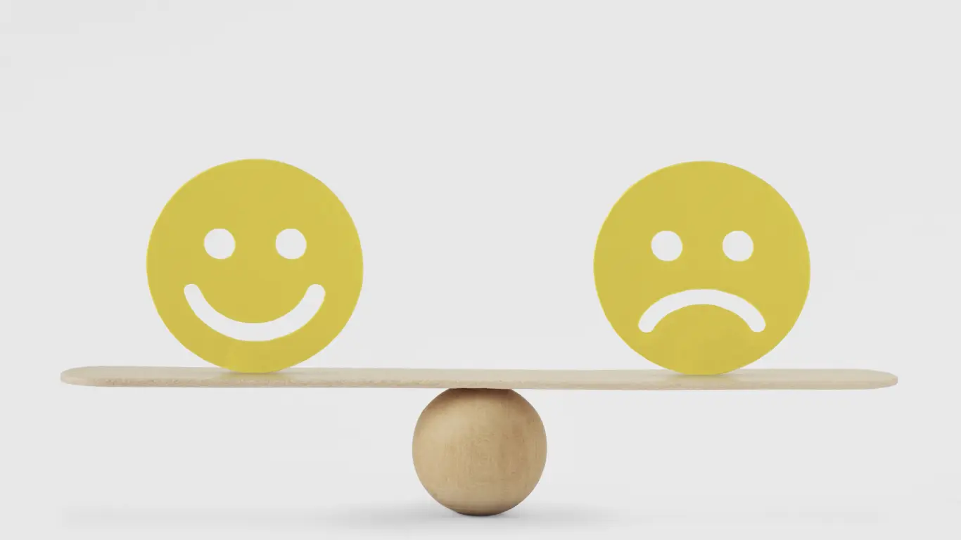 Happy & Sad Emotion balanced on a see-saw.